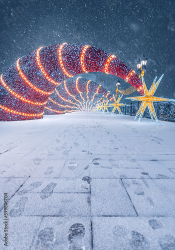 The "Shooting Star" decoration near the Cathedral of Christ the Savior. New Year's Moscow. Snowfall in the city. Patriarch's Bridge in winter.