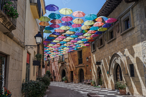 Umbrellas Suspended and Joined with Each other in a Street of Poble Espanyol to Form a Roof of Colorful Umbrellas, Barcelona, Spain photo