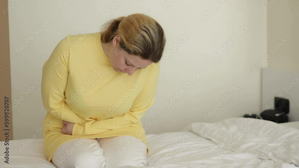 appendicitis, pain in the abdomen, diseases of the stomach and intestines, poisoning, a woman holds her stomach with her hand appendicitis, pain in the abdomen, diseases of the stomach and intestines, poisoning, a woman holds her stomach with her hand