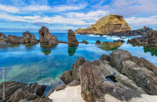 Lava rocks natural volcanic pools in Porto Moniz, Madeira island, Portugal. Dramatic seascape. Beauty of nature concept background. Panoramic view.
