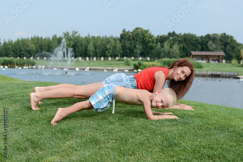 Mom and son are engaged in outdoor sports in the park. Healthy lifestyle concept.