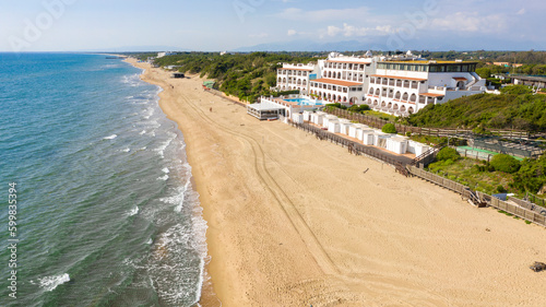 Aerial view of a large white hotel built on the coast of the Mediterranean sea. © Stefano Tammaro