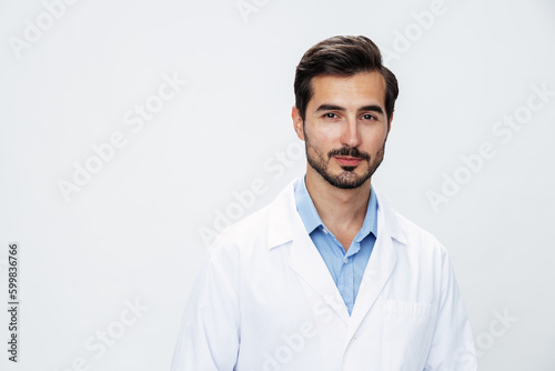 Man doctor in white coat looking into camera on white isolated background, copy space, space for text, health