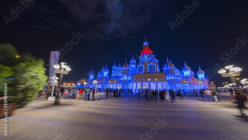 Time lapse Hyper lapse walking in Dubai Global village show miniature Saint Basil's Cathedral with visitors at night.