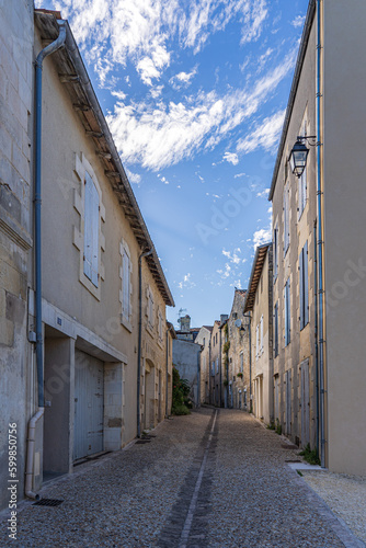 narrow street with stone walls on both sides in France