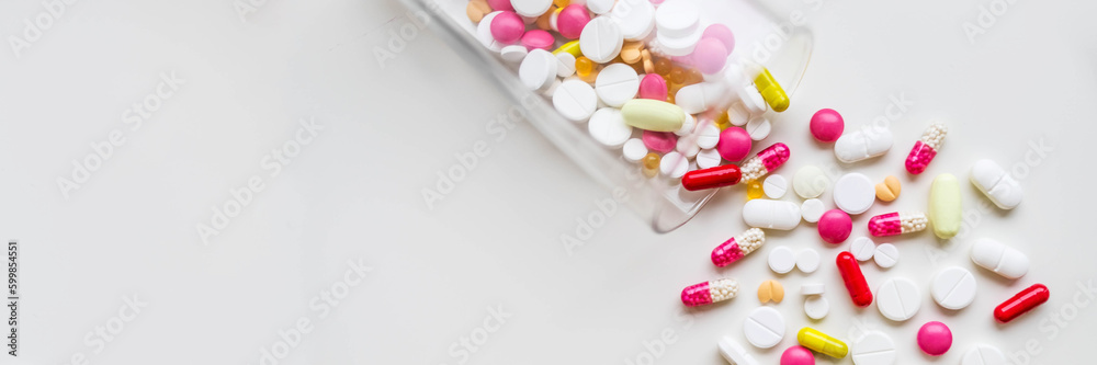 Many colorful tablets spilling out of package, Medicine, medical insurance or pharmacy concept .copy space.Addictive pain relief drug.prescription for treatment medication. Pharmaceutical medicament Many colorful tablets spilling out of package, Medicine, medical insurance or pharmacy concept .copy space.Addictive pain relief drug.prescription for treatment medication. Pharmaceutical medicament