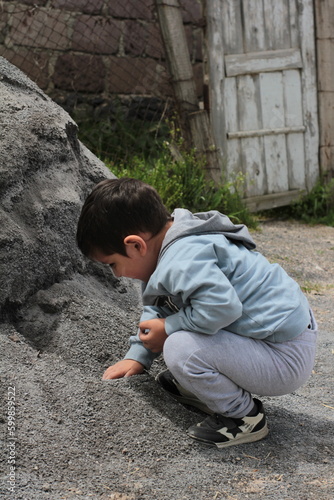 boy playing in the sandbox