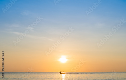 Sunset sky clouds over sea in the morning with orange sunrise over traditional fishing boat, Landscape seaside horizon in summer season