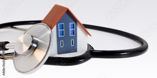 Research of pathologies and diseases of the building - Sick Building Syndrome in Buildings activity and construction industry concept with a small home model and stethoscope photo