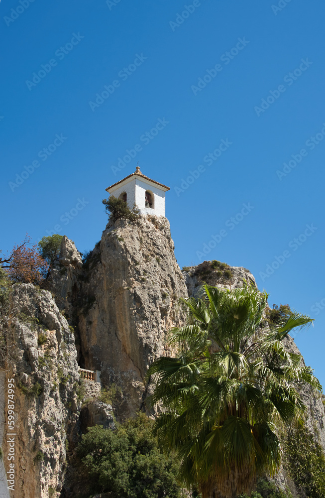 bell turret on rock in nice weather and sunshine in guadalest in spain