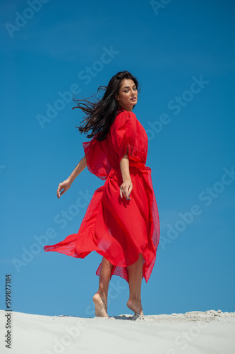 Beautiful woman on white sand wearing beach wear