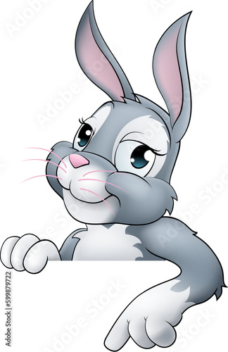 An Easter bunny rabbit cartoon character peeking around a sign