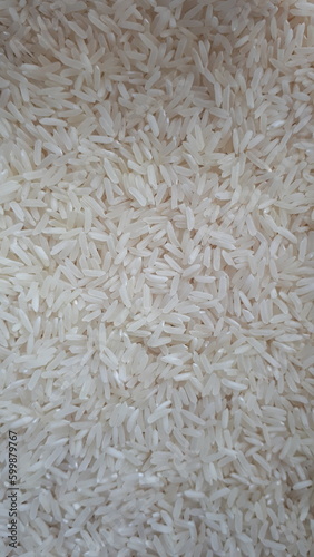 Background. Grain rice. A scattering of cereals.