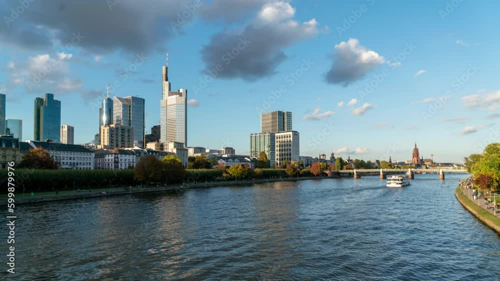 Stunning timelapse of Frankfurt's skyline, featuring its iconic skyscrapers, traffic on the bridge, and a bustling promenade on a partly cloudy day. Stunning timelapse of Frankfurt's skyline, featuring its iconic skyscrapers, traffic on the bridge, and a bustling promenade on a partly cloudy day.