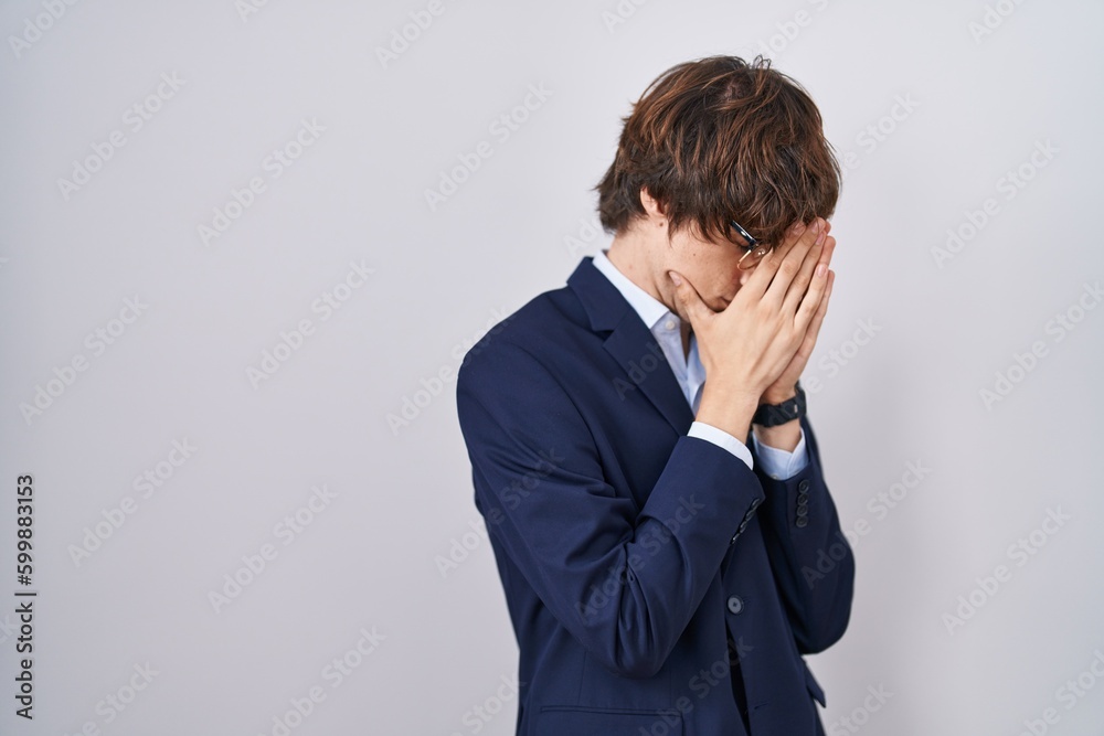 Hispanic business young man wearing glasses with sad expression covering face with hands while crying. depression concept. Hispanic business young man wearing glasses with sad expression covering face with hands while crying. depression concept.