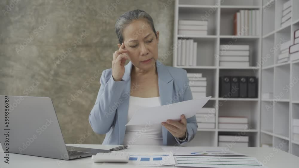 Senior businesswoman working with financial graph document on laptop computer Female financial advisor discussing retirement savings details working from home 4k Senior businesswoman working with financial graph document on laptop computer Female financial advisor discussing retirement savings details working from home 4k
