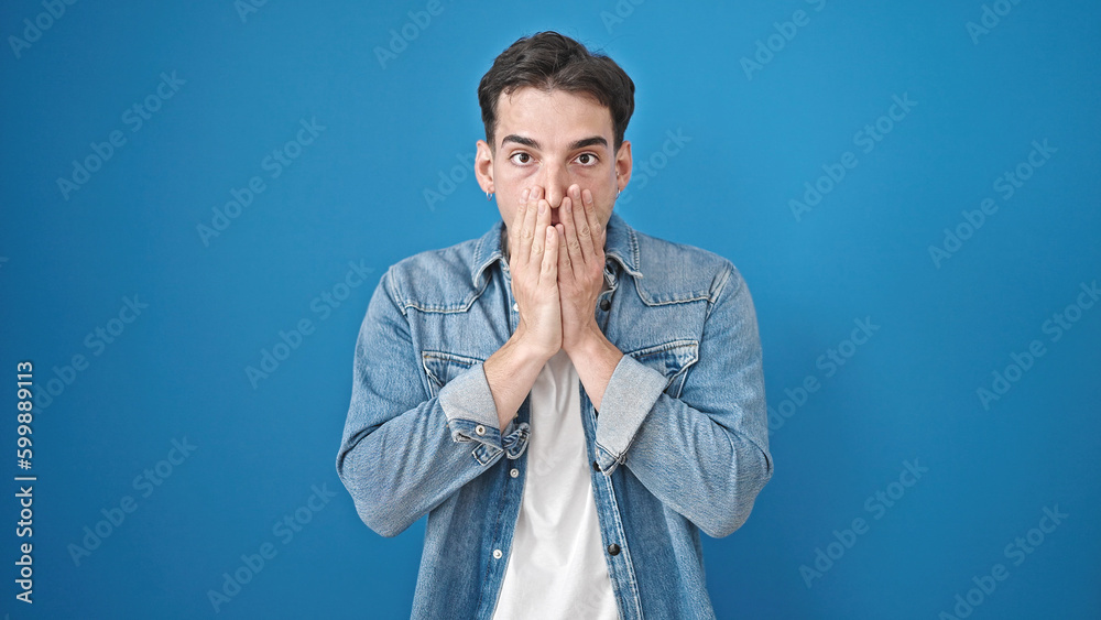 Young hispanic man standing with surprise expression over isolated blue background Young hispanic man standing with surprise expression over isolated blue background