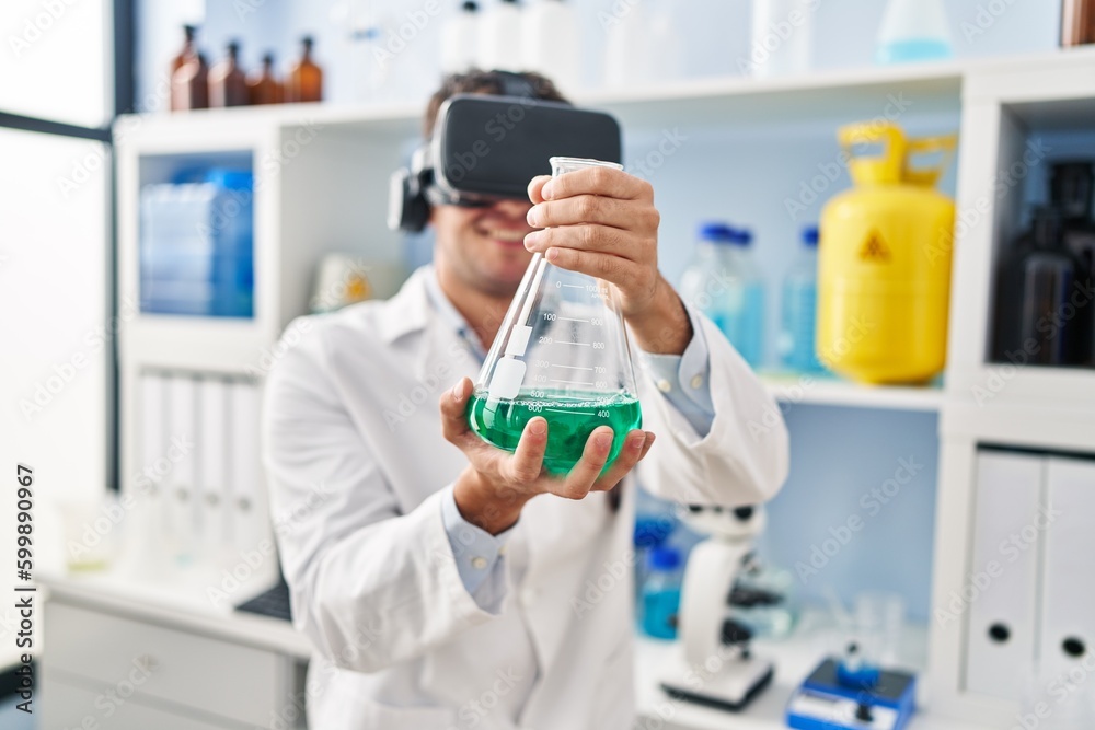 Young hispanic man scientist using virtual reality glasses holding test tube at laboratory Young hispanic man scientist using virtual reality glasses holding test tube at laboratory