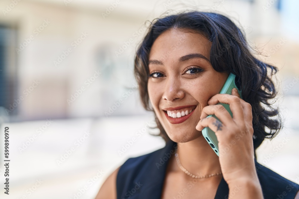 Young beautiful hispanic woman smiling confident talking on the smartphone at street Young beautiful hispanic woman smiling confident talking on the smartphone at street