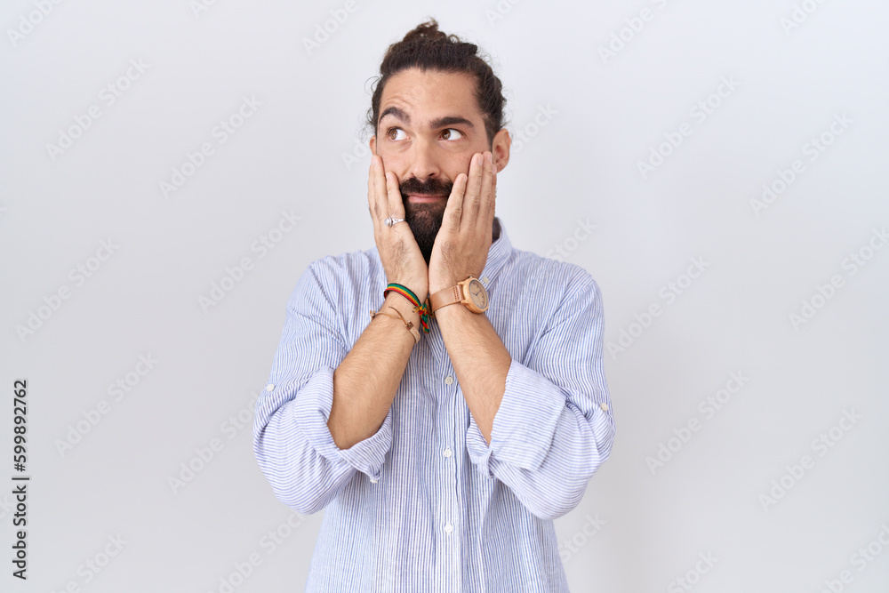Hispanic man with beard wearing casual shirt tired hands covering face, depression and sadness, upset and irritated for problem Hispanic man with beard wearing casual shirt tired hands covering face, depression and sadness, upset and irritated for problem
