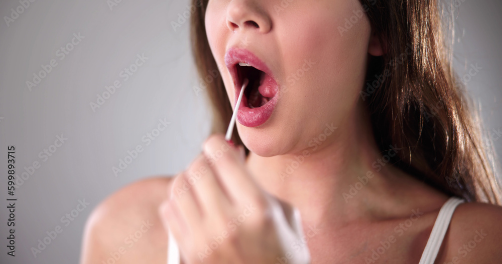 Dentist's Hand Taking Saliva Test From Woman's Mouth Dentist's Hand Taking Saliva Test From Woman's Mouth