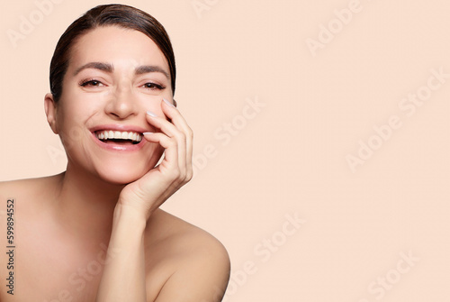 Beauty and Skincare Concept. Smiling natural woman with nude makeup on a flawless skin