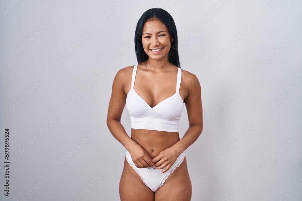 Hispanic woman wearing lingerie with a happy and cool smile on face. lucky person. - obrazy, fototapety, plakaty 