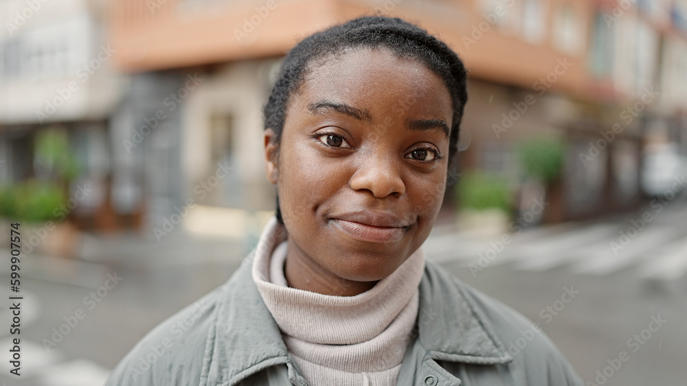 African american woman standing with relaxed expression at street African american woman standing with relaxed expression at street