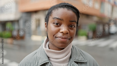 African american woman standing with relaxed expression at street