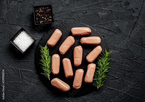 raw sausages on a stone background