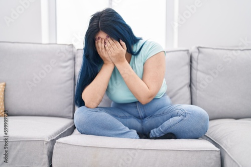 Young caucasian woman stressed sitting on sofa at home © Krakenimages.com