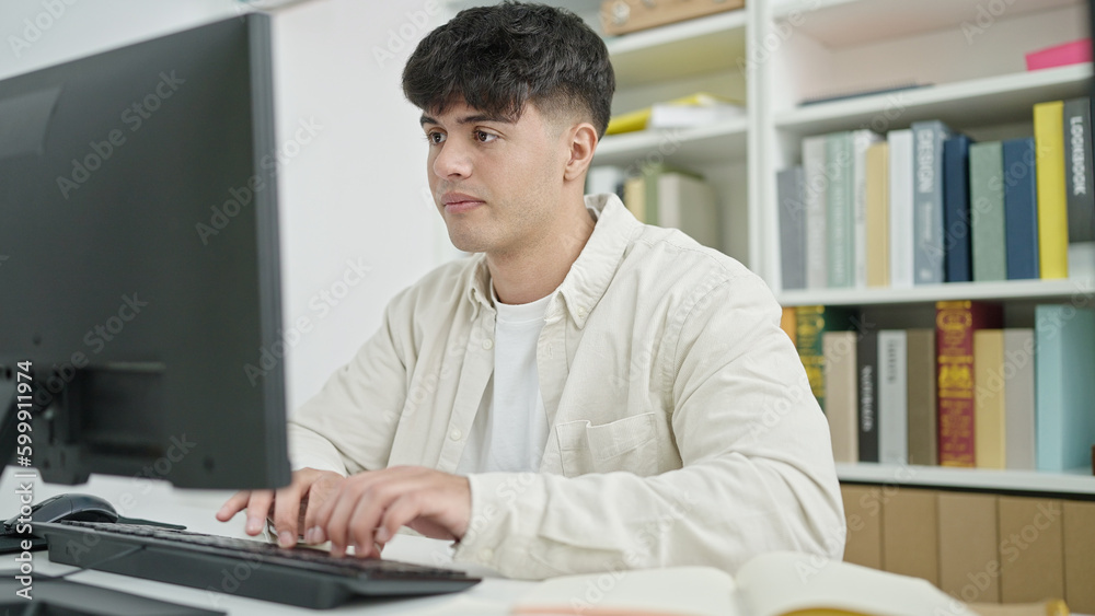 Young hispanic man student using computer studying at library university Young hispanic man student using computer studying at library university