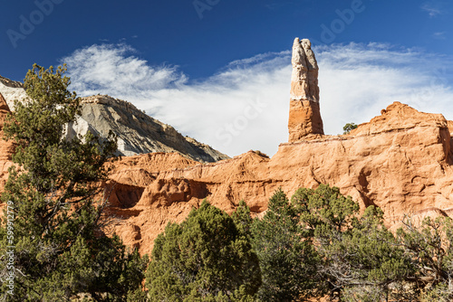 Red sandstone pinnacle on a ridge in Bryce Canyon National Park Utah with blue clouds and clouds .