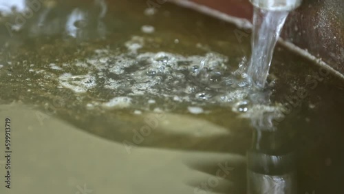 Adding lye solution to natural organic oils in saponification soap making