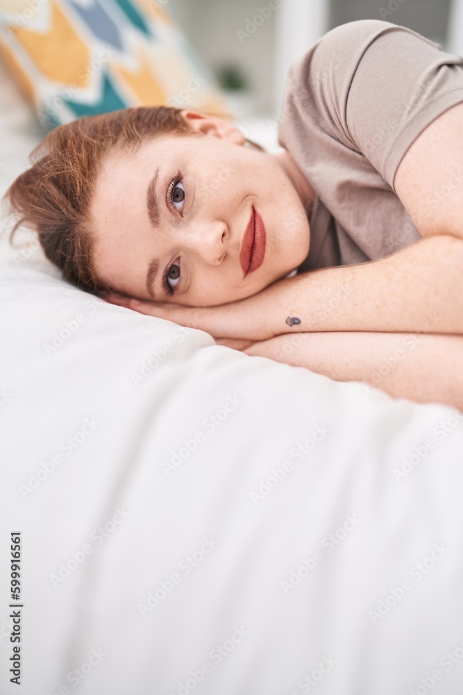 Young redhead woman smiling confident lying on bed at bedroom Young redhead woman smiling confident lying on bed at bedroom