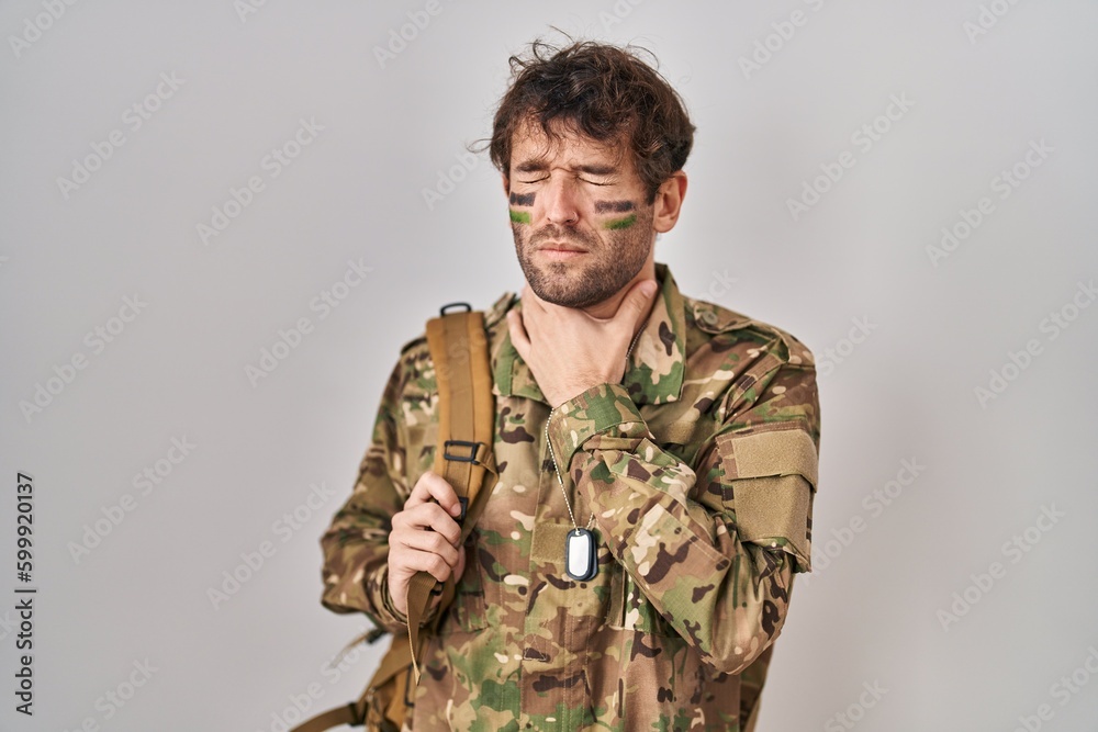 Hispanic young man wearing camouflage army uniform touching painful neck, sore throat for flu, clod and infection