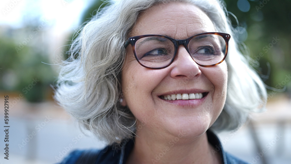 Middle age woman with grey hair smiling confident at street Middle age woman with grey hair smiling confident at street