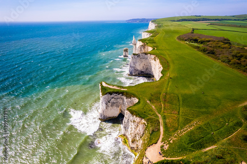 Fototapet Aerial  view of limestone cliffs and stacks with countryside at Old Harry Rocks in Dorset, UK