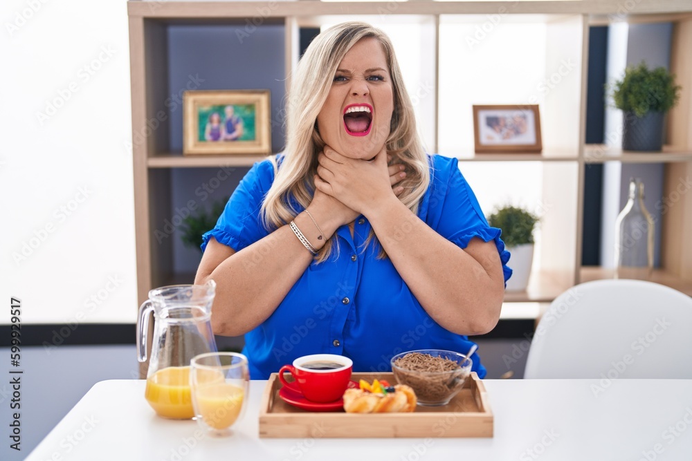 Caucasian plus size woman eating breakfast at home shouting and suffocate because painful strangle. health problem. asphyxiate and suicide concept. Caucasian plus size woman eating breakfast at home shouting and suffocate because painful strangle. health problem. asphyxiate and suicide concept.