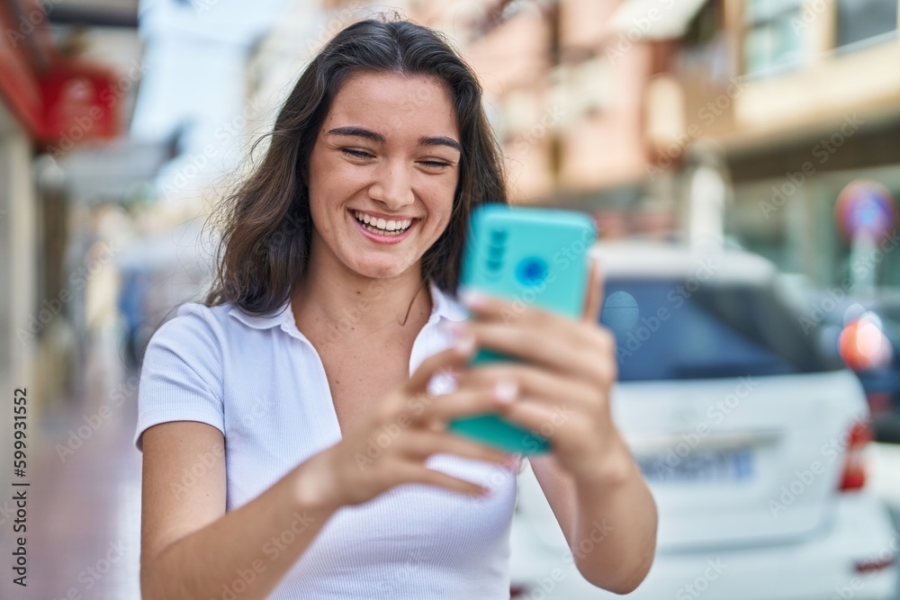 Young hispanic woman smiling confident using smartphone at street Young hispanic woman smiling confident using smartphone at street