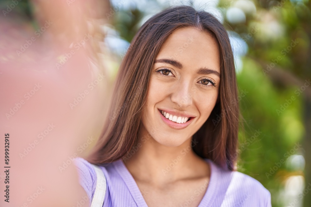 Young beautiful hispanic woman smiling confident making selfie by camera at park Young beautiful hispanic woman smiling confident making selfie by camera at park