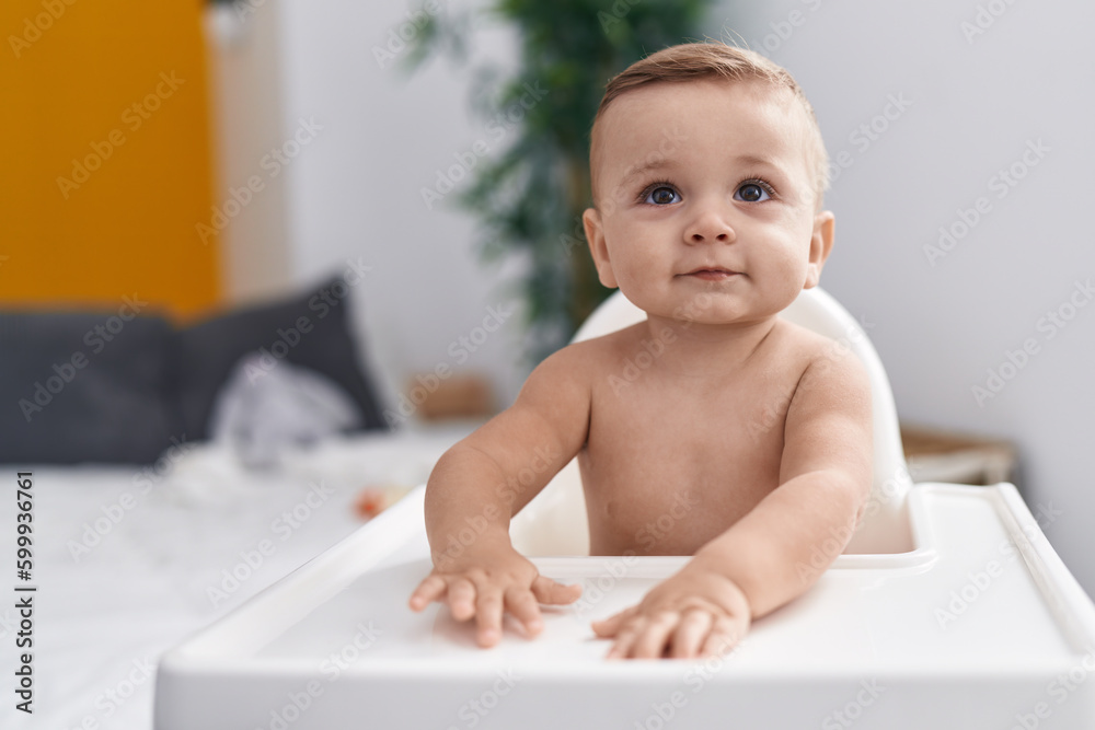 Adorable caucasian baby sitting on highchair at home Adorable caucasian baby sitting on highchair at home