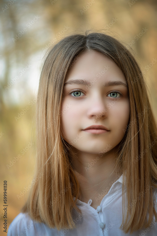 Portrait of a young beautiful blonde girl in a summer park. Portrait of a young beautiful blonde girl in a summer park.