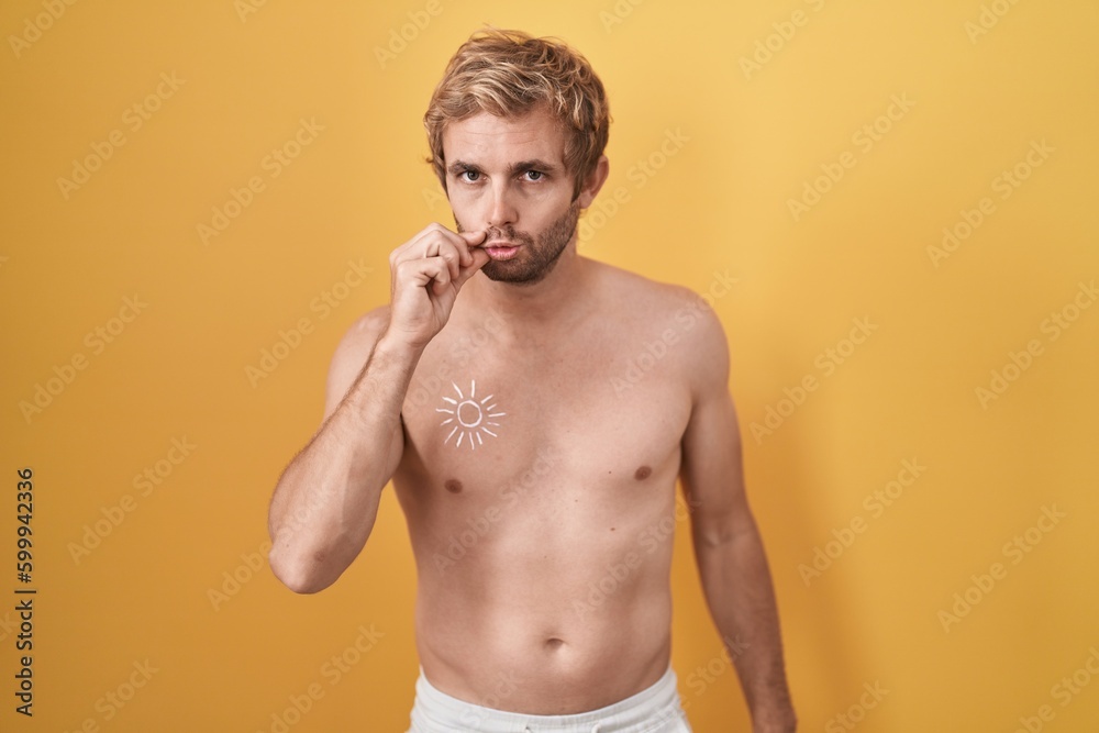 Caucasian man standing shirtless wearing sun screen mouth and lips shut as zip with fingers. secret and silent, taboo talking