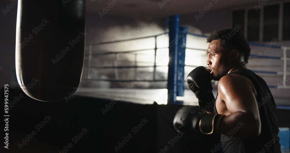 Copy space. Close up. African athlete working with a boxing pear, punching it with boxing gloves, preparing for a tournament - sports, active way of life concept 