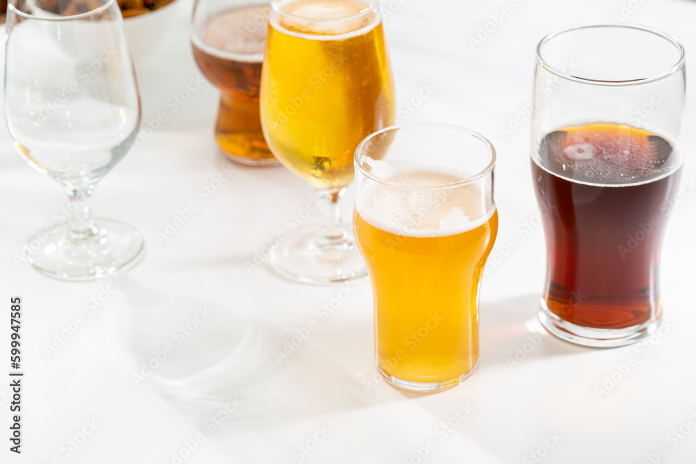 Glass set with light beer dark on light background party concept