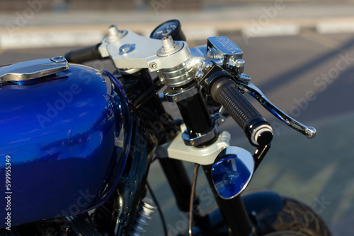 close-up of a motorcycle steering wheel with a speedometer
