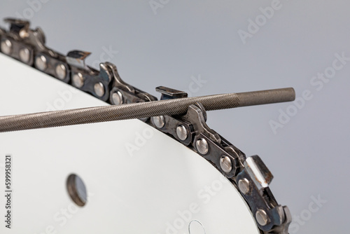 Foto Sharpening chainsaw chain with file