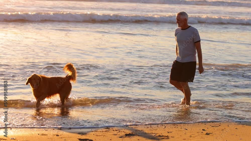 64 year old man getting his exercise at the beach at sunset. Slow Motion.
