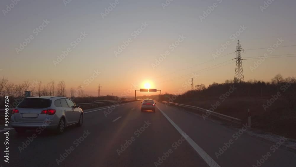 Vacation travel concept of cars driving on highway at sunset, sunrise Vacation travel concept of cars driving on highway at sunset, sunrise